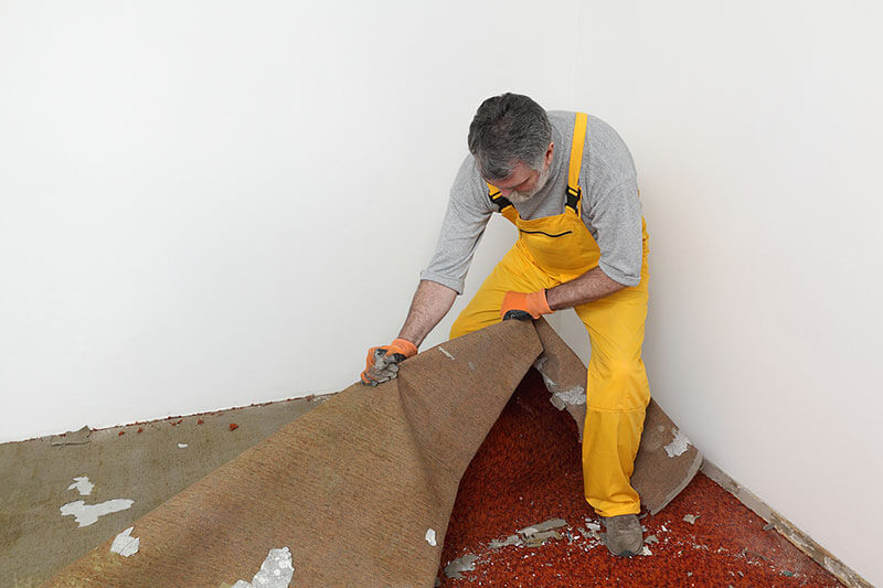 Old carpet being removed and replaced with new carpet