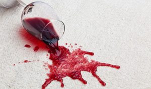Fresh red wine spilled on a light-coloured carpet
